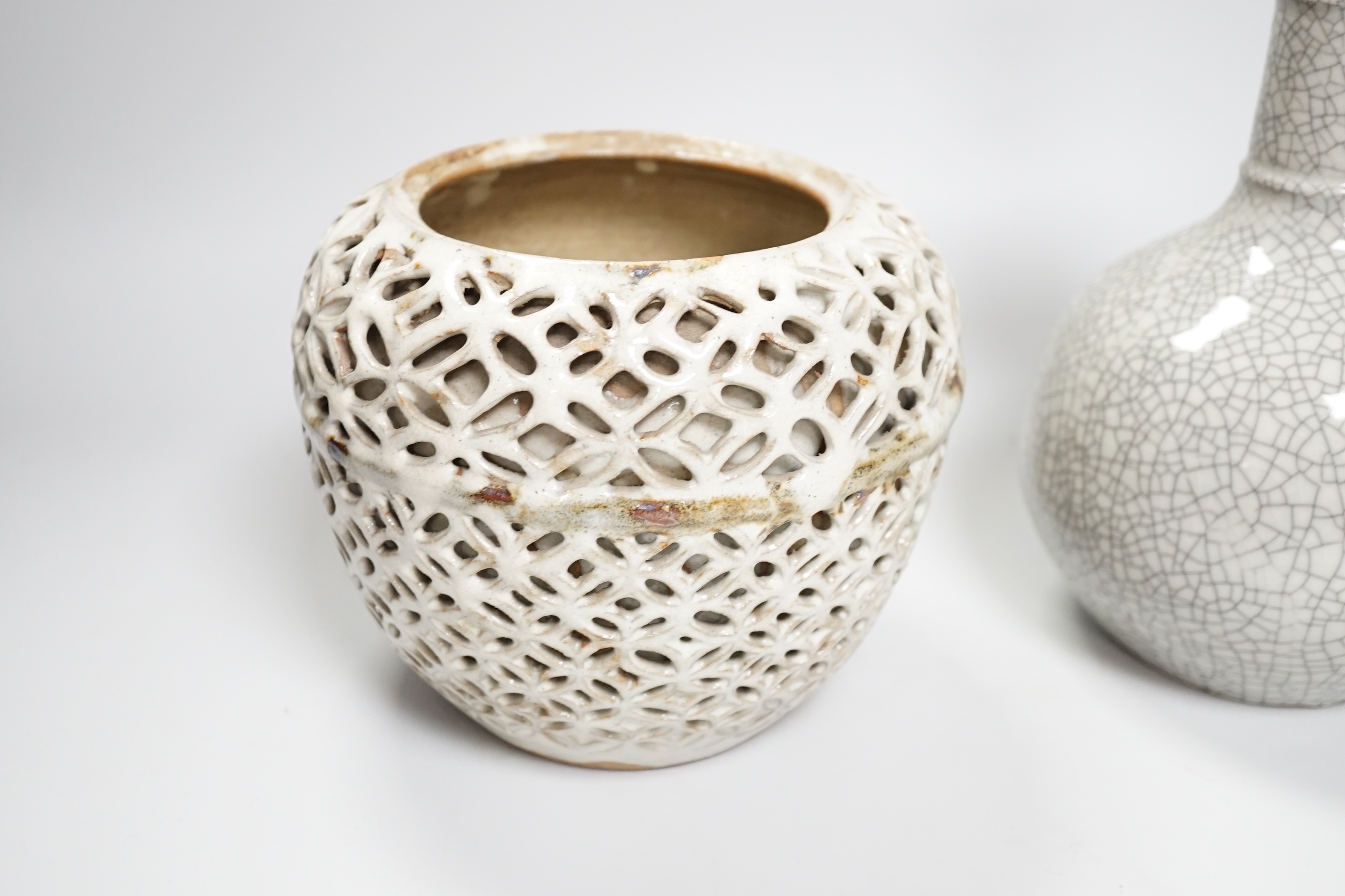 A Chinese crackle glaze bottle vase, a reticulated pottery vase and pottery vase, tallest 23cm high